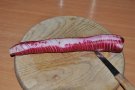 Roter Rettich in dünnen Scheiben geschnitten auf Holzbrett